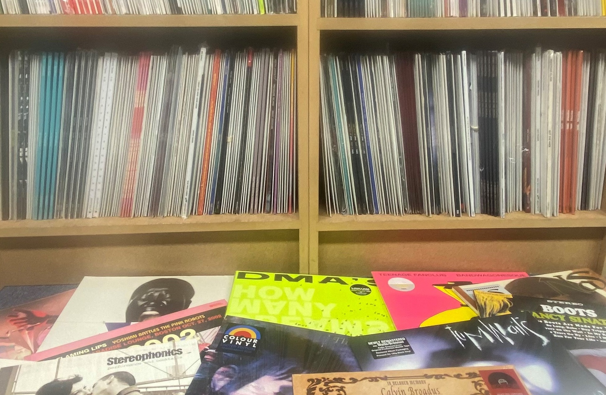 A collection of records on offer on a shelf